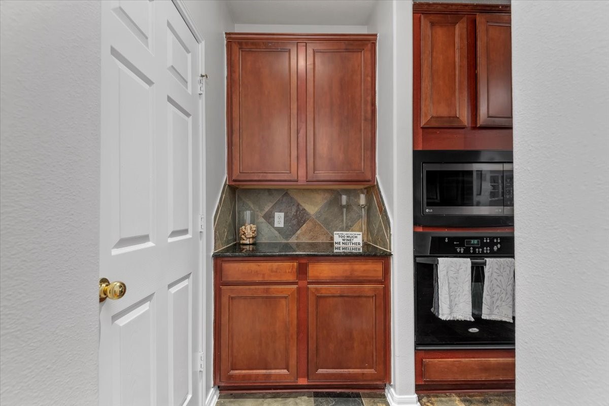 6507 Quiet Pointe Drive Spring, TX 77389 - Photo 14 of 46 Coffee Nook or Wine Bar – To the left of the kitchen, you’ll find additional built-in cabinetry, perfect for creating a cozy coffee station or an elegant wine bar—ideal for both coffee lovers and wine enthusiasts.