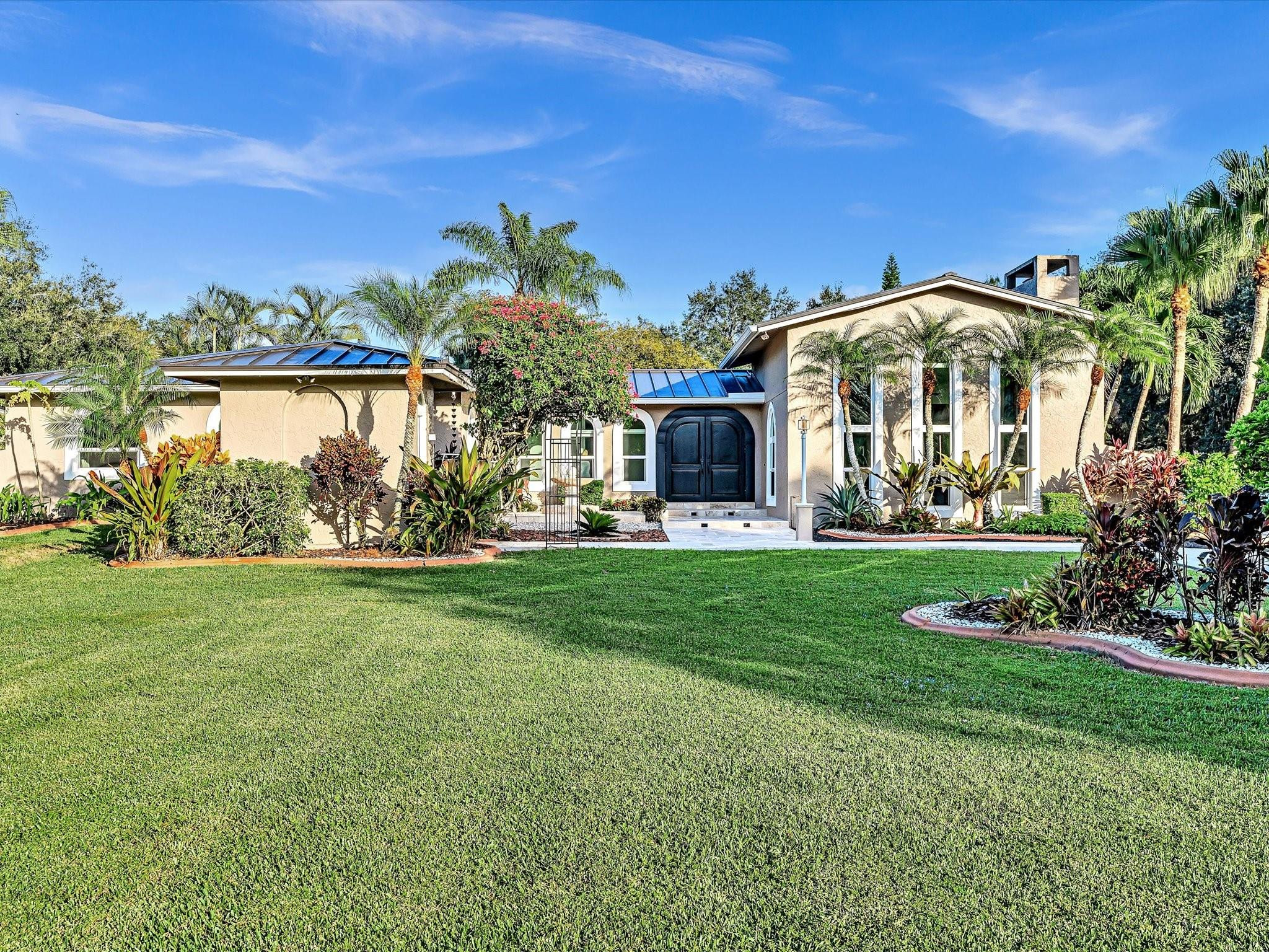 a front view of a house with garden