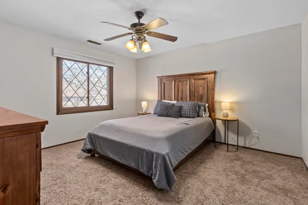 a bedroom with a bed and a chandelier
