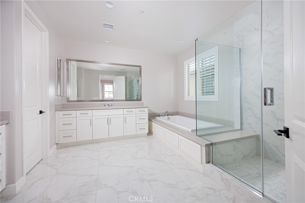 2017 Picasso Santa Ana, CA 92704 - Photo 11 of 31 a spacious bathroom with a granite countertop sink a mirror and a bathtub