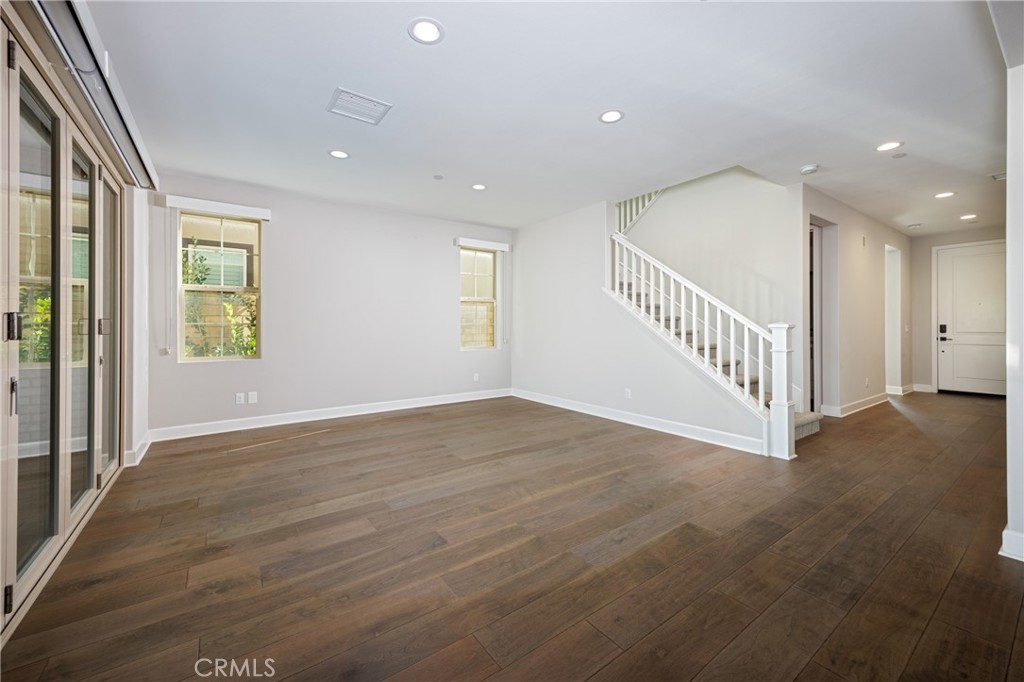 2017 Picasso Santa Ana, CA 92704 - Photo 6 of 31 a view of an empty room with wooden floor and windows