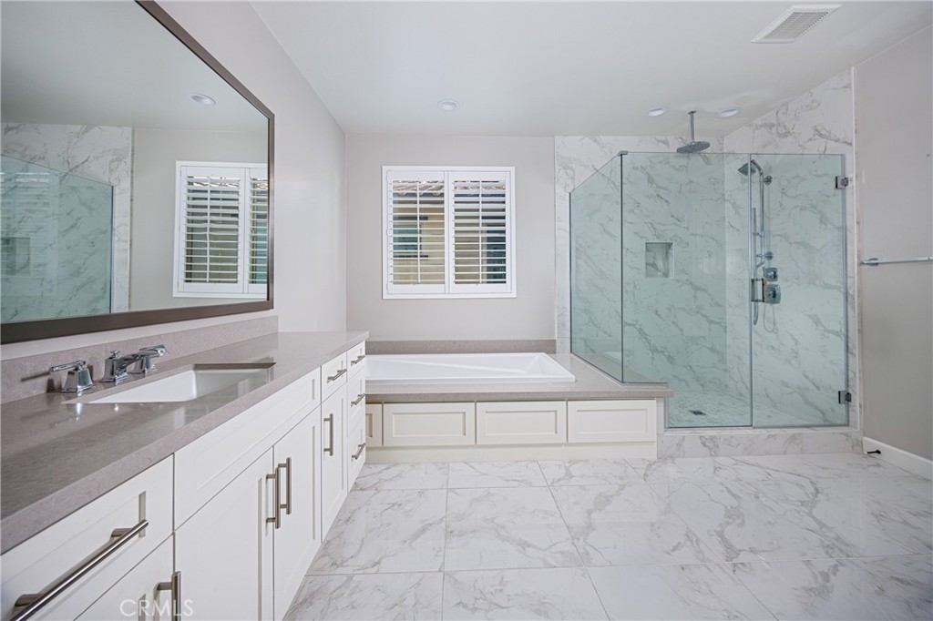 2017 Picasso Santa Ana, CA 92704 - Photo 9 of 31 a spacious bathroom with a granite countertop sink a toilet a vanity and shower