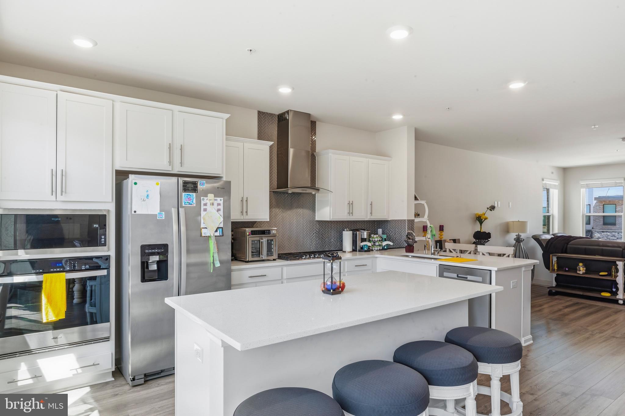870 Amity Street Frederick, MD 21701 - Photo 16 of 56 a kitchen with a sink a stove and chairs