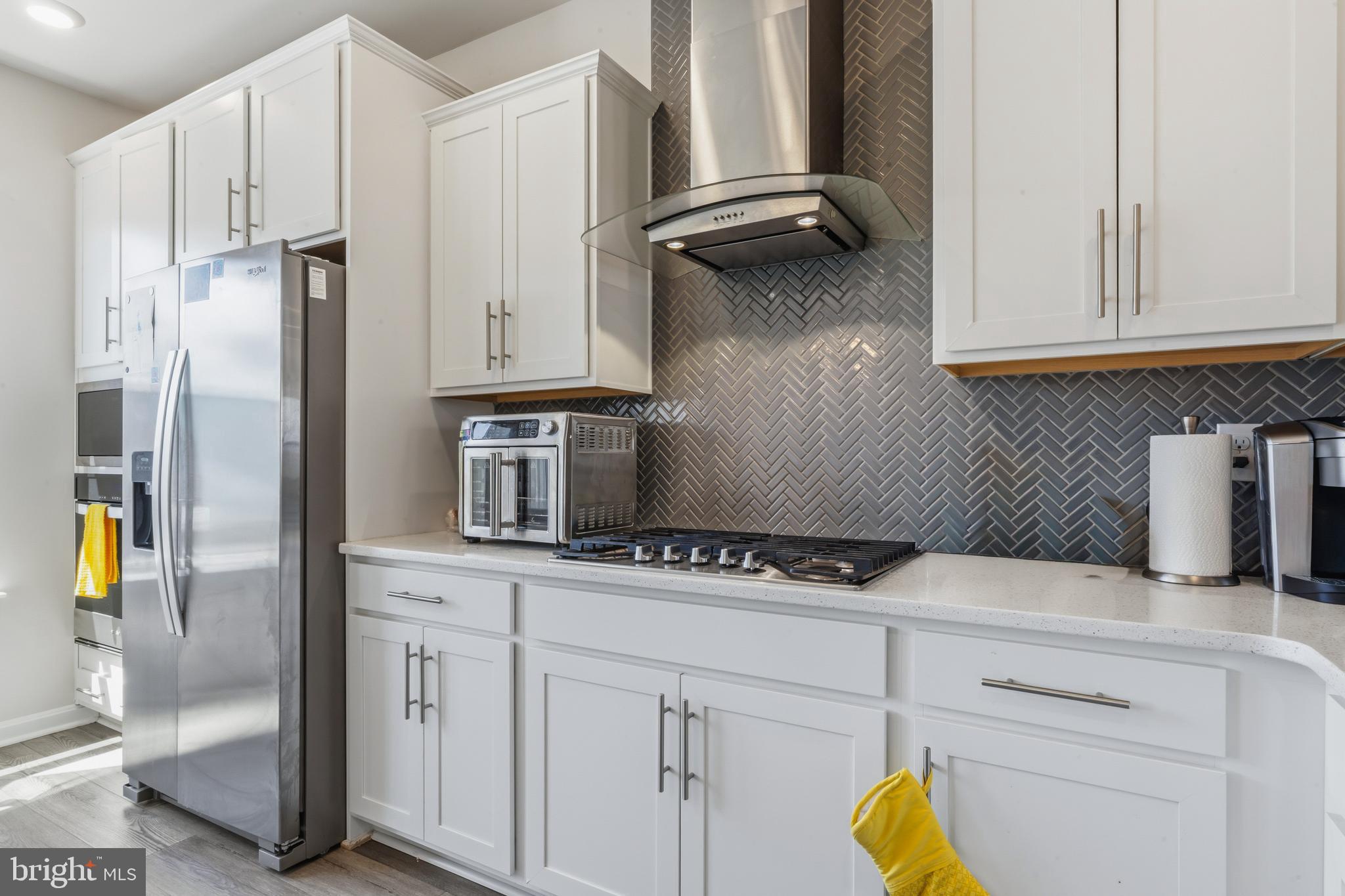 870 Amity Street Frederick, MD 21701 - Photo 19 of 56 a kitchen with stainless steel appliances a stove a refrigerator and cabinets