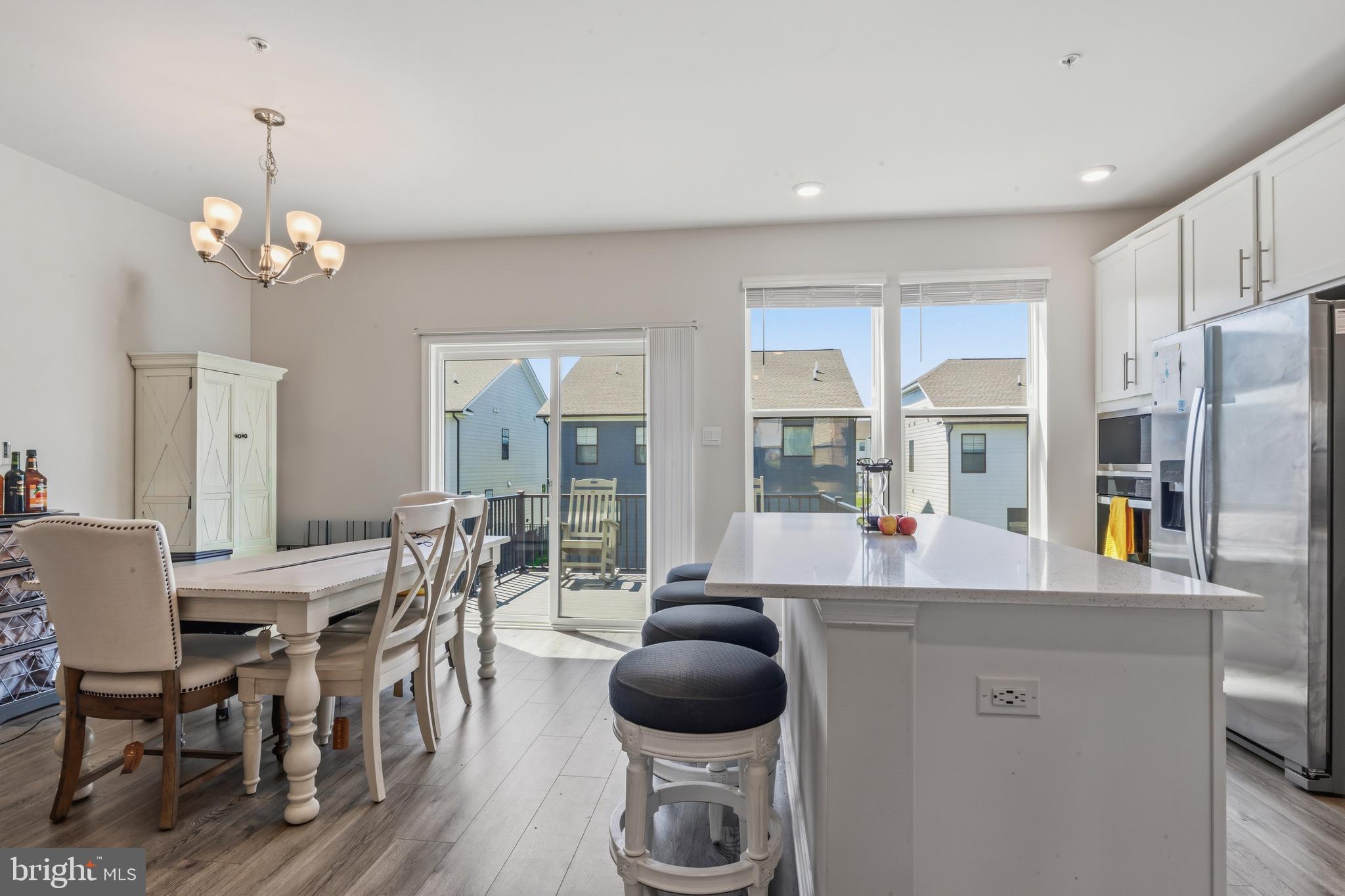 870 Amity Street Frederick, MD 21701 - Photo 20 of 56 a kitchen with stainless steel appliances a dining table chairs and chandelier