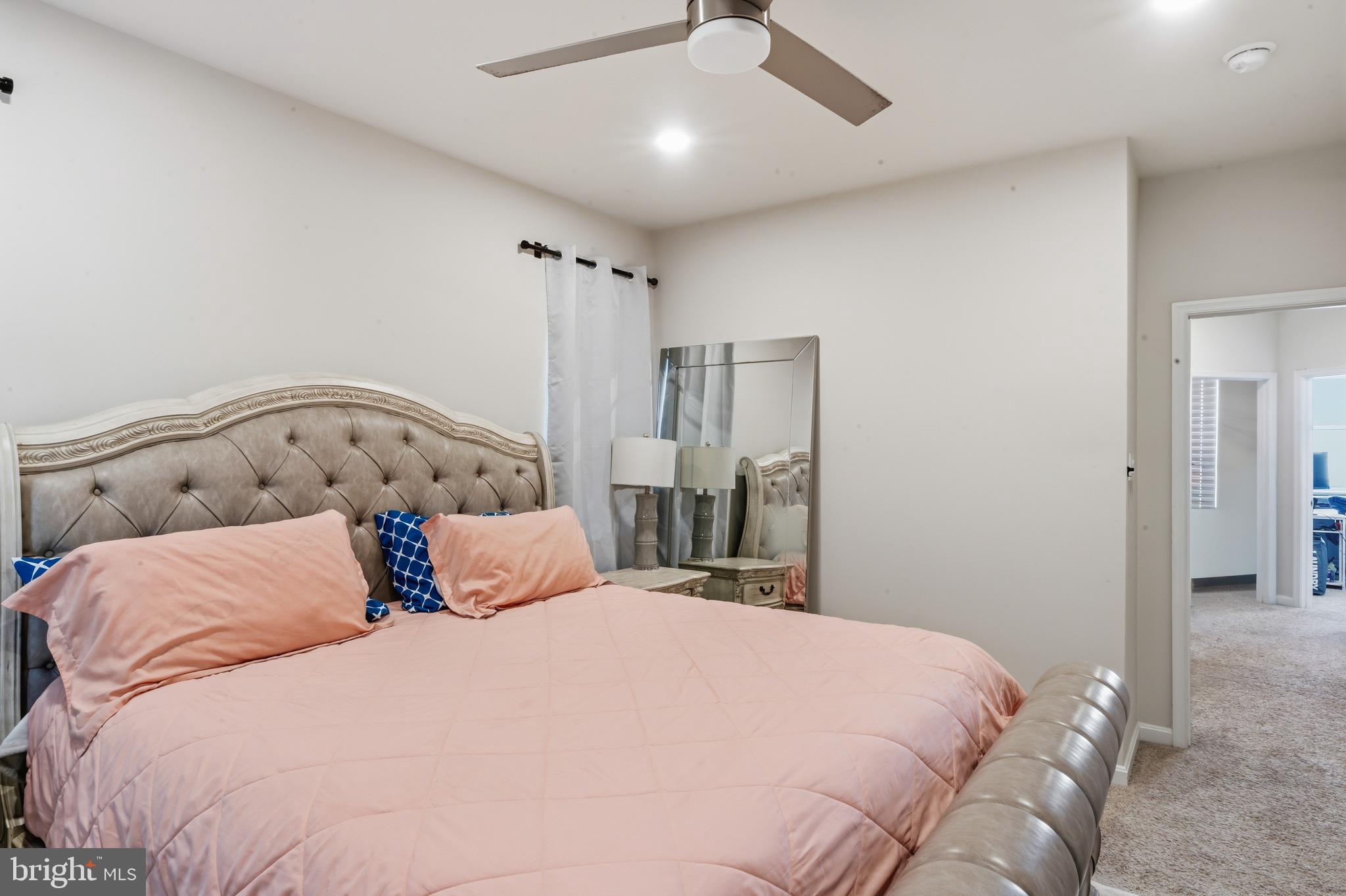 870 Amity Street Frederick, MD 21701 - Photo 37 of 56 a bedroom with a large bed and a chandelier