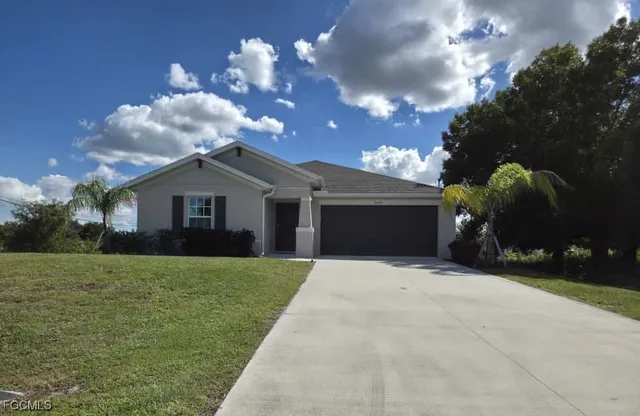 a front view of a house with a yard and garage
