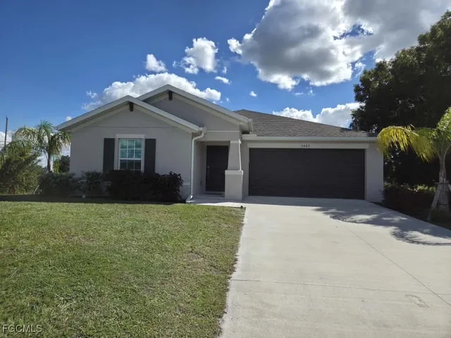 a front view of a house with a yard and garage