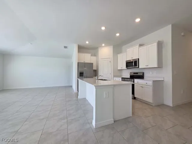 a kitchen with cabinets and stainless steel appliances