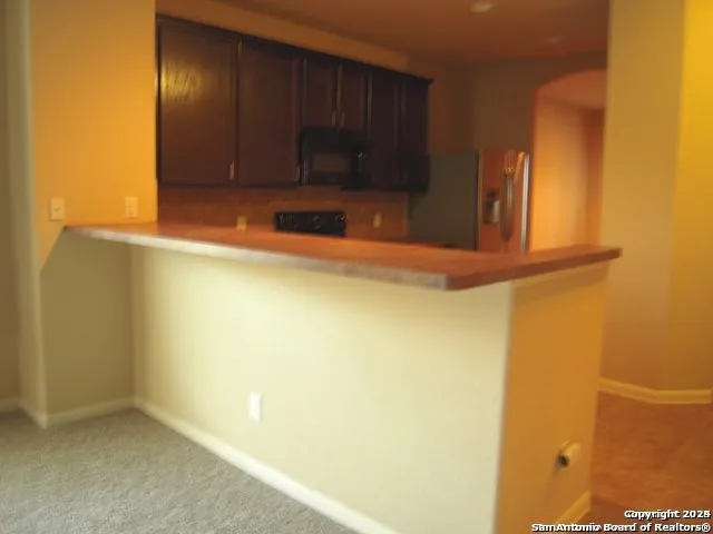 a view of a closet with wooden floor