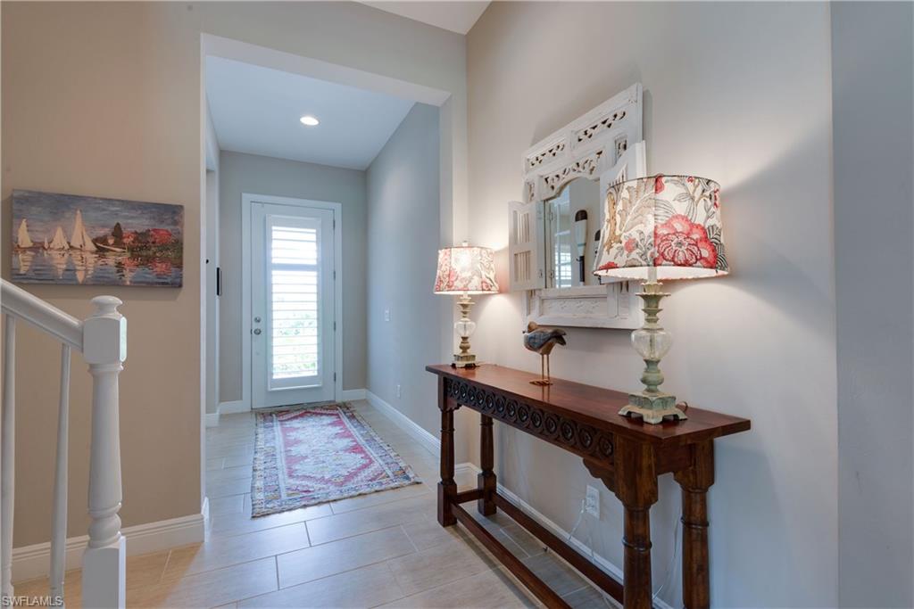 4068 Raffia Drive Naples, FL 34119 - Photo 2 of 25 Beautiful natural light floods the foyer through the glass panel front door. Custom shutters have been installed here in addition to the rest of the windows.