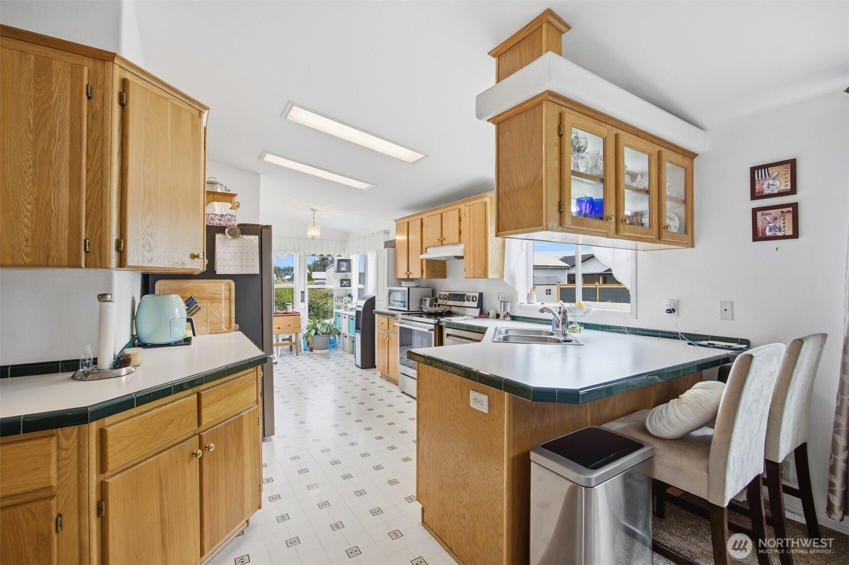 380 East Pole Road, Unit 6 Lynden, WA 98264 - Photo 12 of 40 a kitchen with granite countertop kitchen island stainless steel appliances a sink stove and a dining table