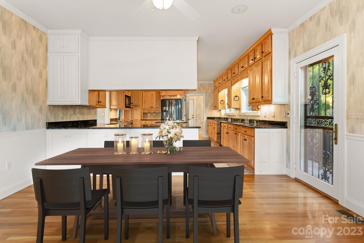 42 Country Club Road Mills River, NC 28759 - Photo 13 of 48 a kitchen with a dining table chairs and cabinets