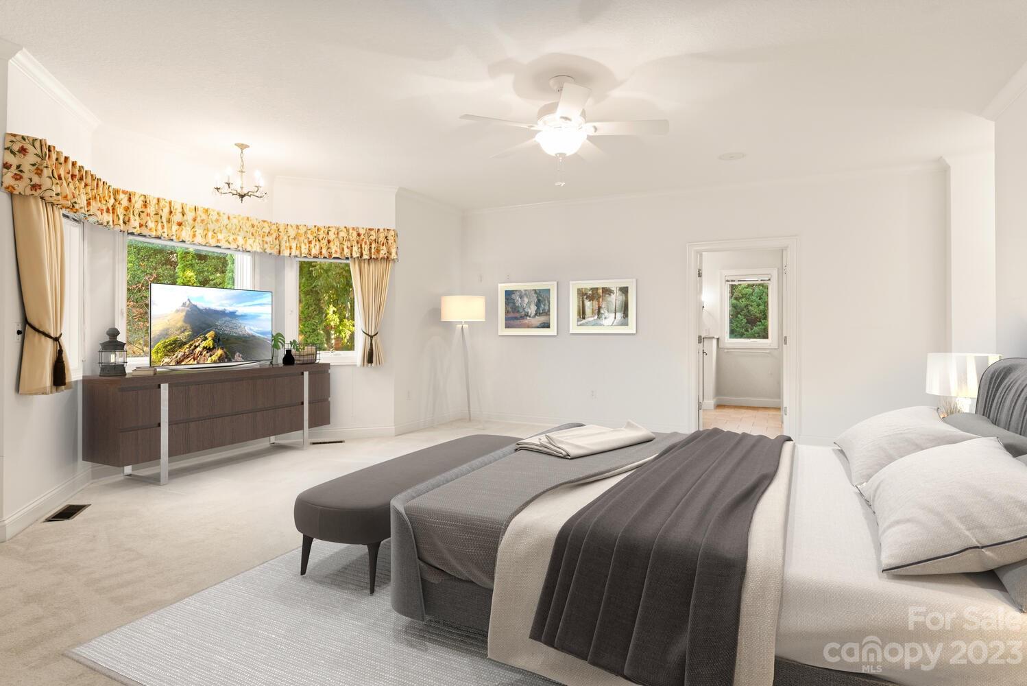 42 Country Club Road Mills River, NC 28759 - Photo 17 of 48 a bedroom with a bed and a chandelier