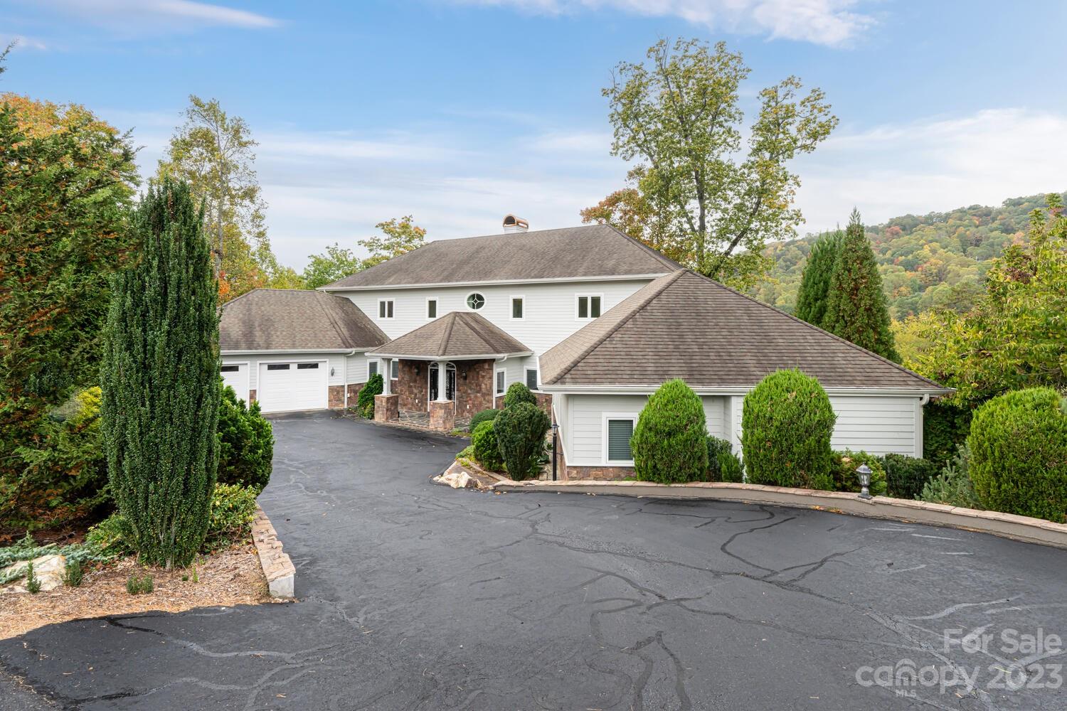 42 Country Club Road Mills River, NC 28759 - Photo 2 of 48 a front view of a house with a yard and garage