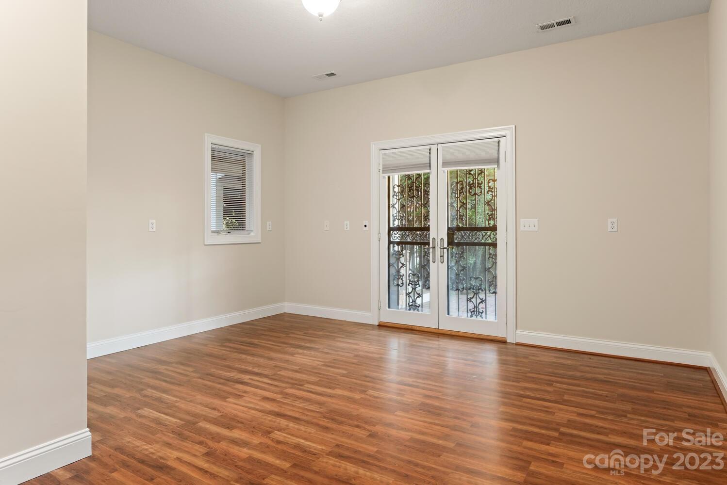 42 Country Club Road Mills River, NC 28759 - Photo 26 of 48 an empty room with wooden floor and windows