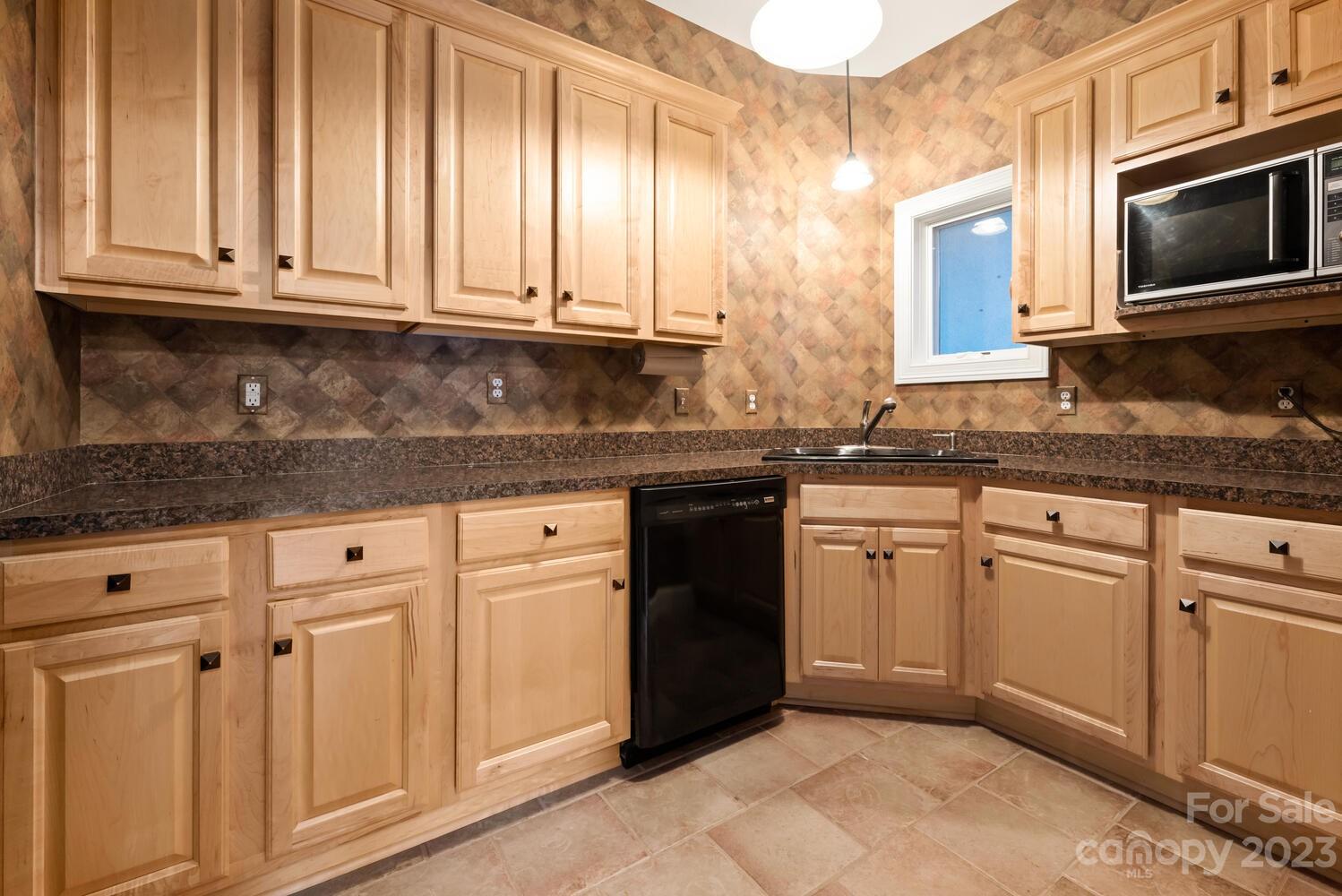 42 Country Club Road Mills River, NC 28759 - Photo 39 of 48 a kitchen with granite countertop white cabinets and stainless steel appliances