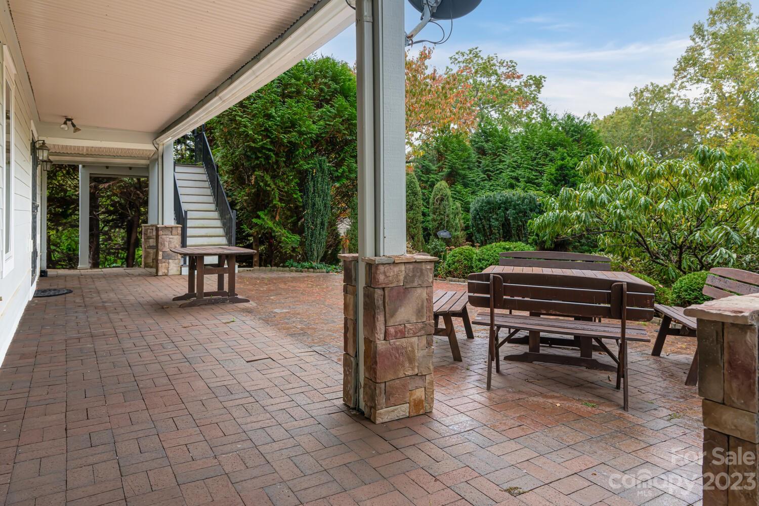 42 Country Club Road Mills River, NC 28759 - Photo 43 of 48 a view of a patio with table and chairs with wooden floor and fence