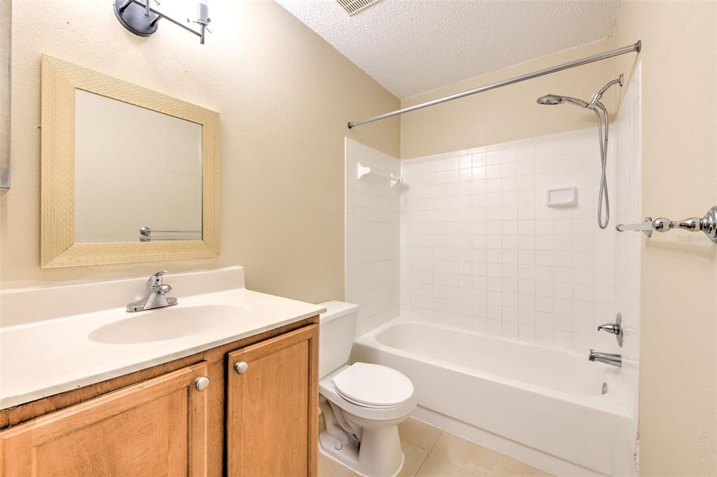 308 Lake Parsons Green, Unit 106 Brandon, FL 33511 - Photo 14 of 26 a bathroom with a sink toilet and shower