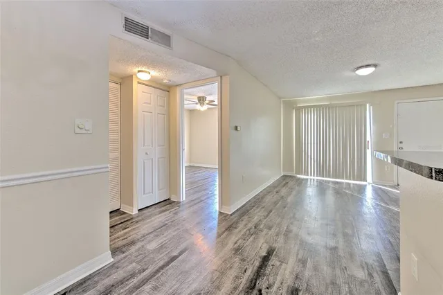a view of a room with wooden floor and a window