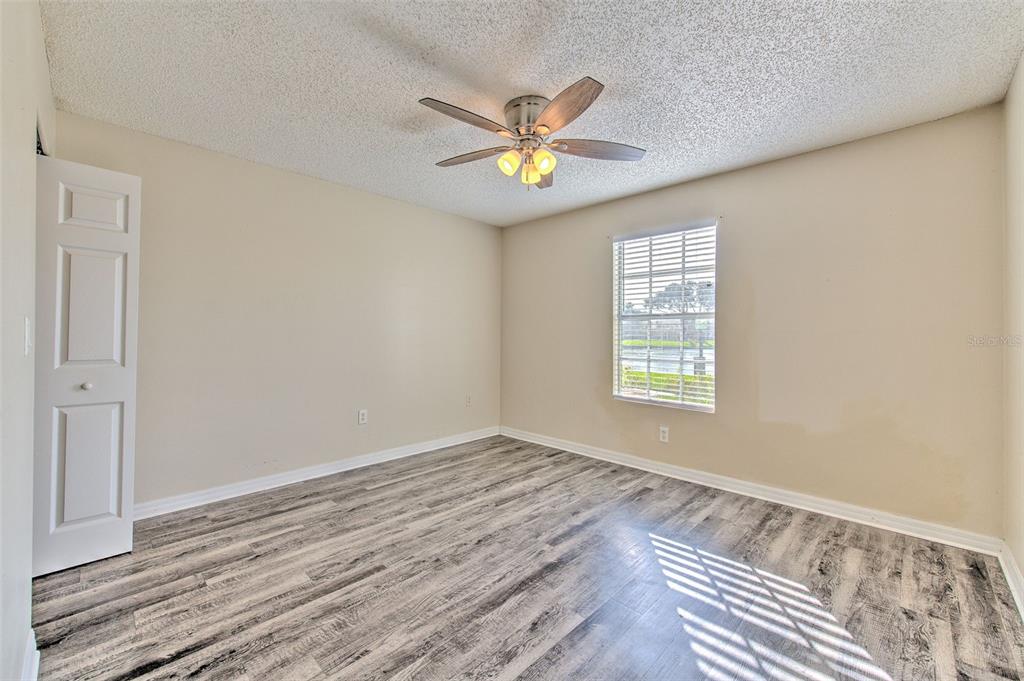 308 Lake Parsons Green, Unit 106 Brandon, FL 33511 - Photo 16 of 26 a view of a room with wooden floor and a window