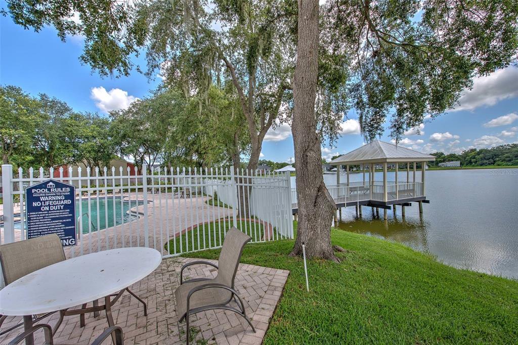 308 Lake Parsons Green, Unit 106 Brandon, FL 33511 - Photo 23 of 26 a view of a chair and table in the garden