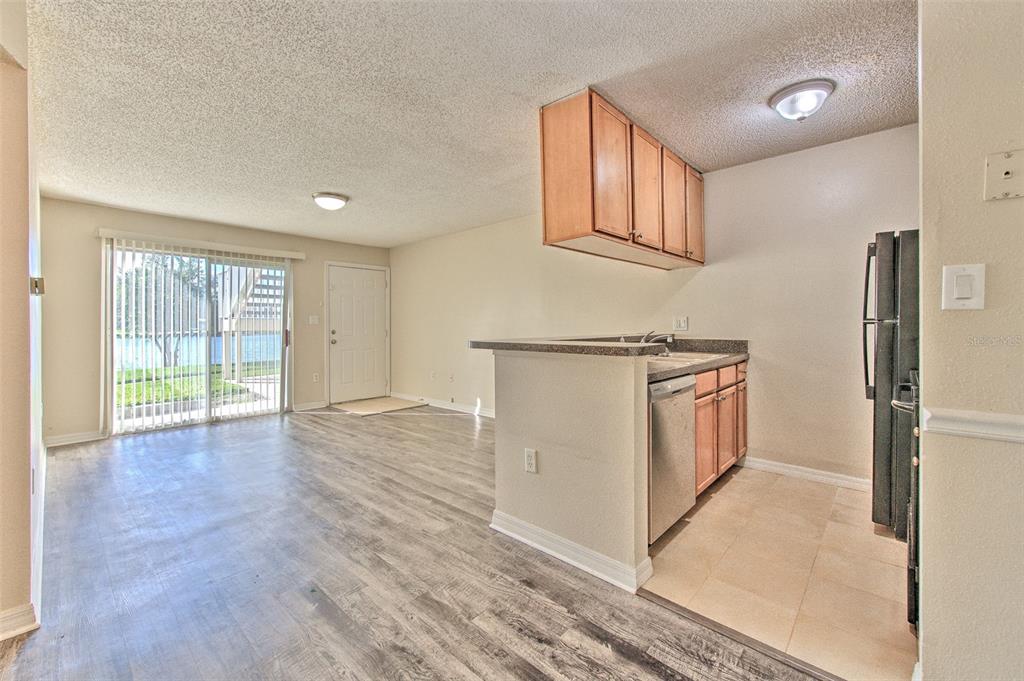 308 Lake Parsons Green, Unit 106 Brandon, FL 33511 - Photo 9 of 26 a view of a kitchen with wooden floor and staircase
