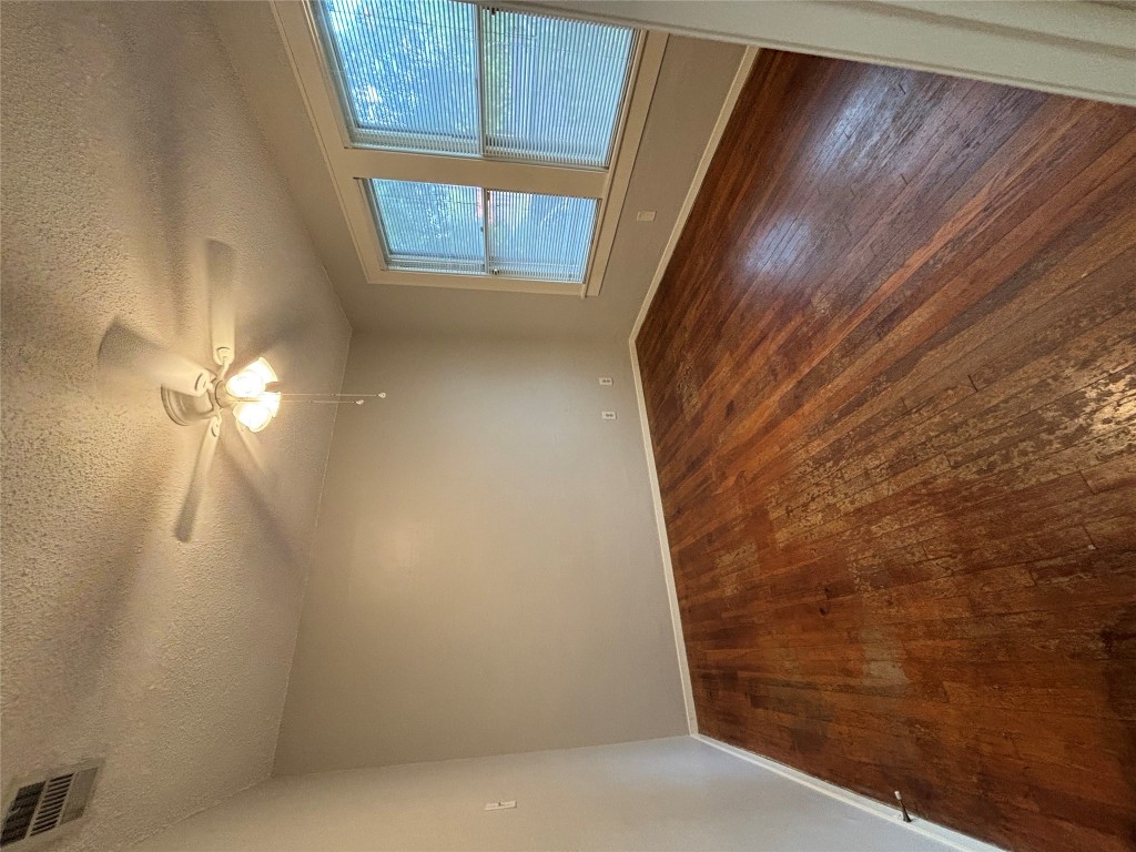 317 West 35th Street, Unit B Austin, TX 78705 - Photo 2 of 9 a view of an empty room with wooden floor and a window