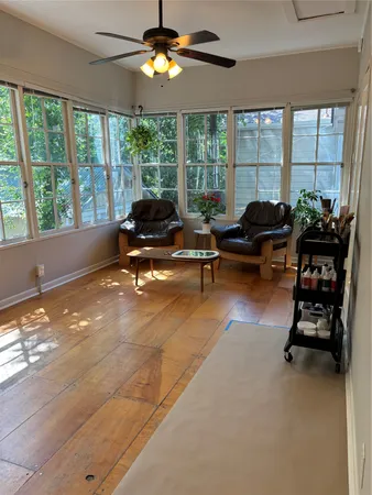 a living room with furniture and large windows