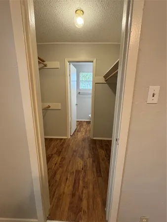 a view of hallway with wooden floor