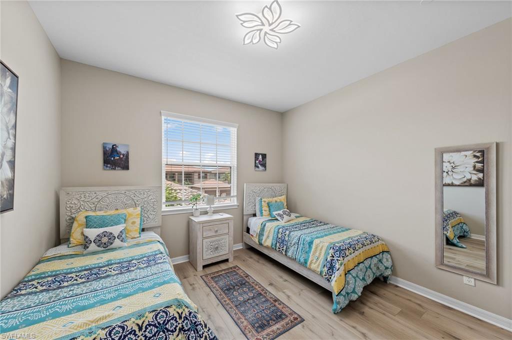 9366 Pocida Court, Unit 202 Naples, FL 34119 - Photo 21 of 44 a bedroom with a bed and a window