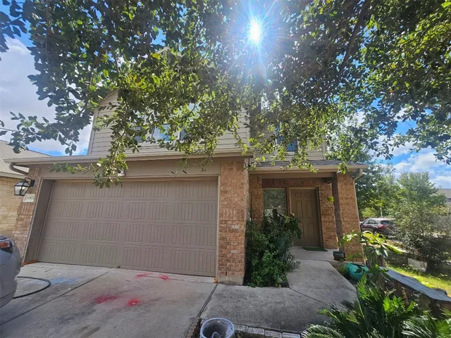 a backyard of a house with plants and trees