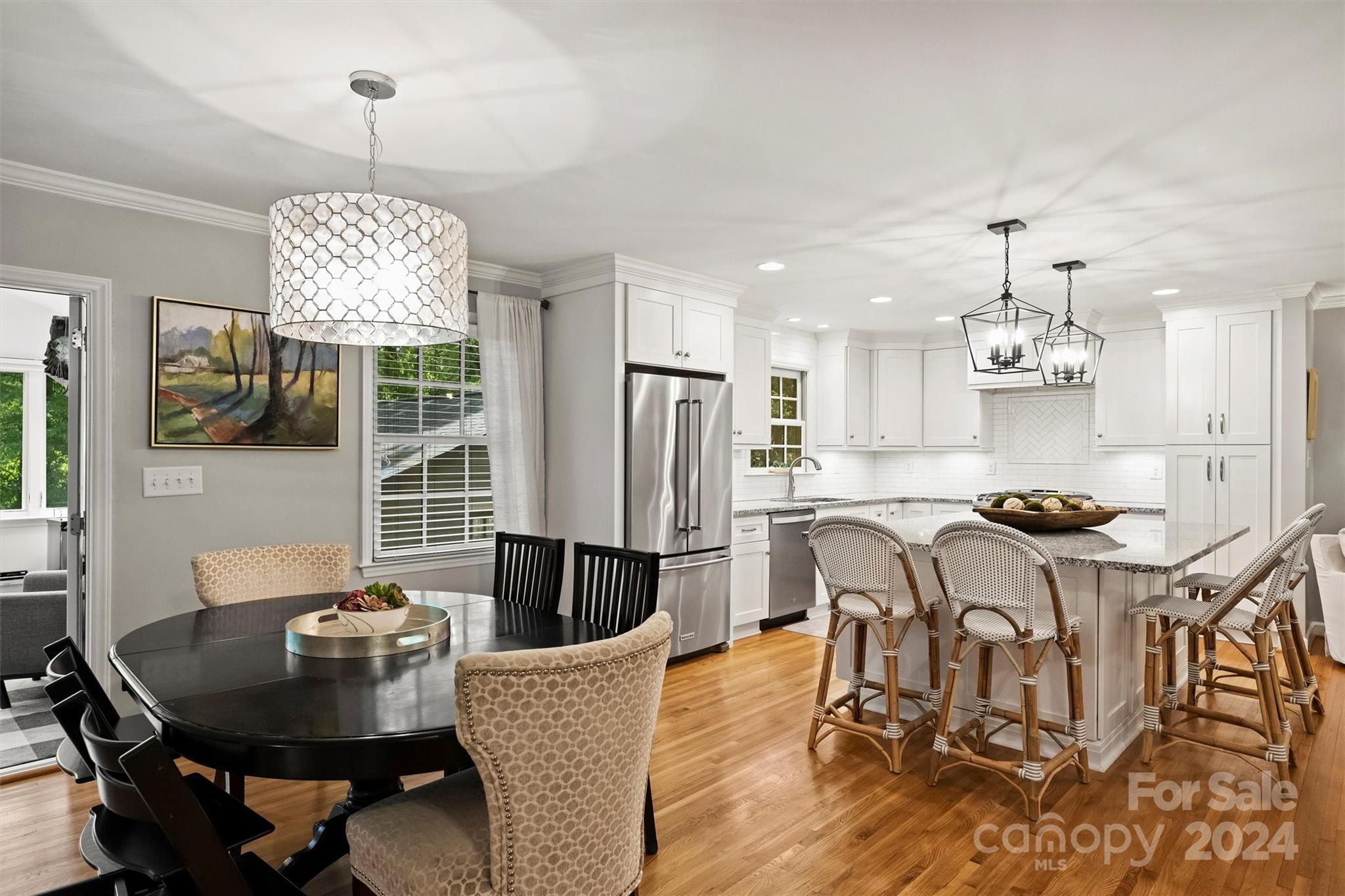 3820 Sulkirk Road Charlotte, NC 28210 - Photo 13 of 48 a dining room with furniture a chandelier and wooden floor