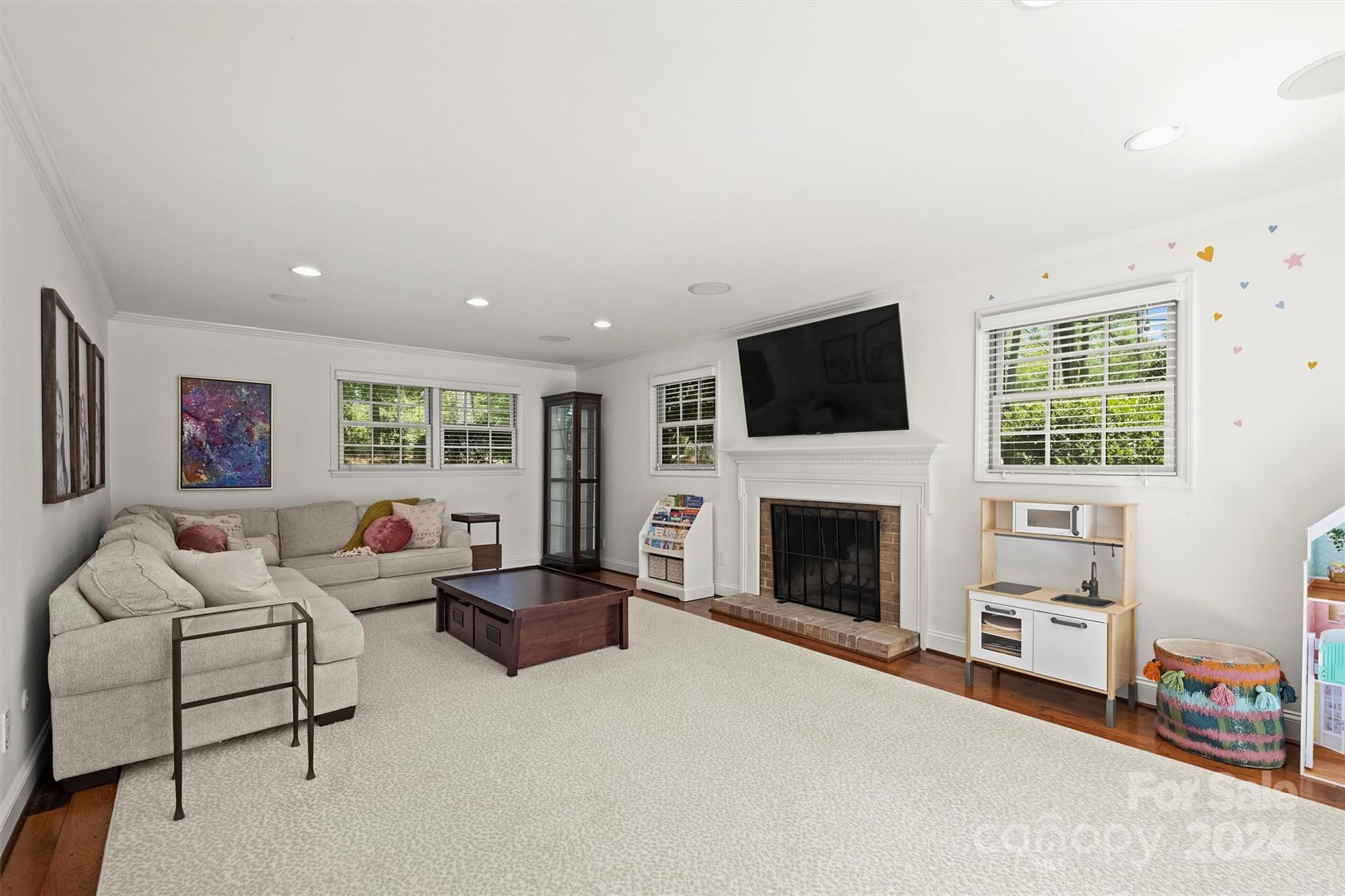 3820 Sulkirk Road Charlotte, NC 28210 - Photo 22 of 48 a living room with furniture a fireplace and a flat screen tv