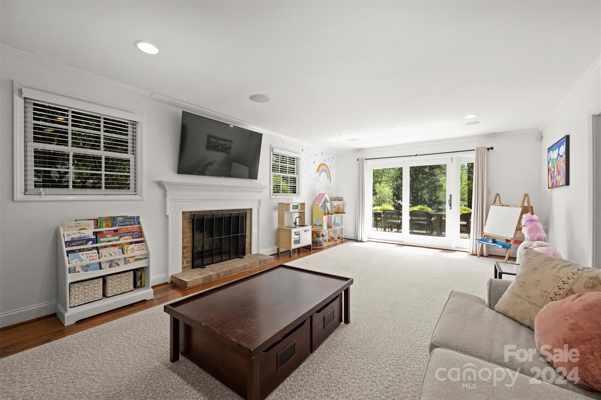 3820 Sulkirk Road Charlotte, NC 28210 - Photo 23 of 48 a living room with furniture a flat screen tv and a fireplace