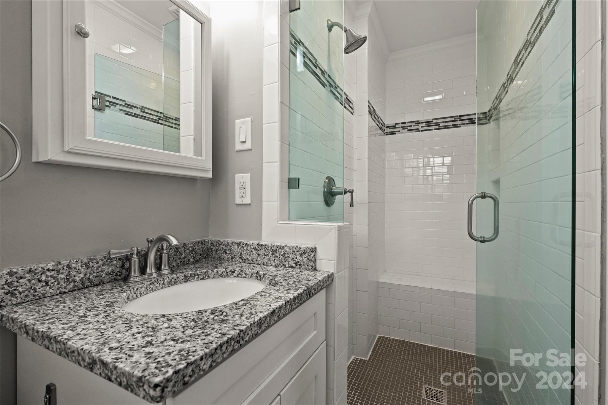 3820 Sulkirk Road Charlotte, NC 28210 - Photo 30 of 48 a bathroom with a granite countertop sink a mirror and shower