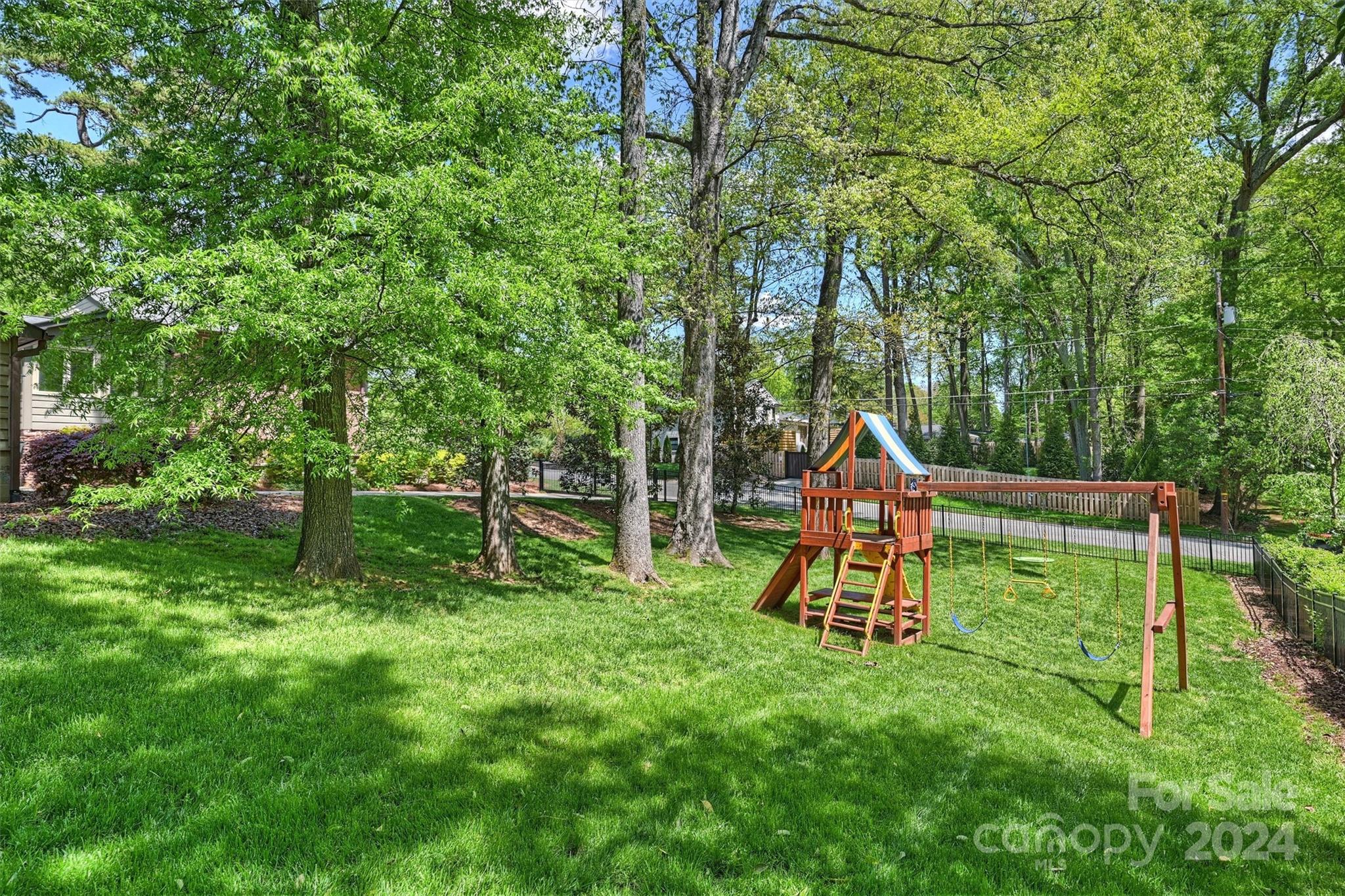 3820 Sulkirk Road Charlotte, NC 28210 - Photo 44 of 48 a backyard of a house with childrens swings and slides
