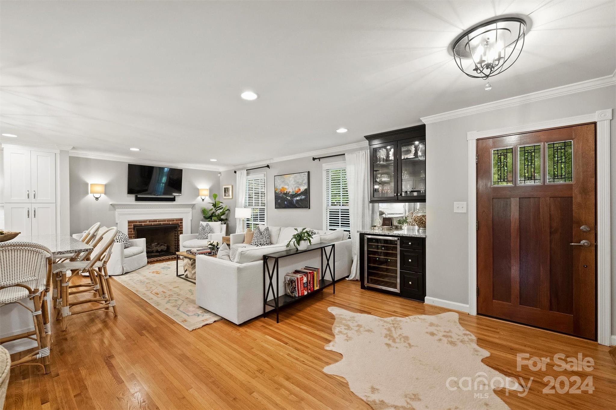 3820 Sulkirk Road Charlotte, NC 28210 - Photo 6 of 48 a living room with furniture a fireplace and a flat screen tv