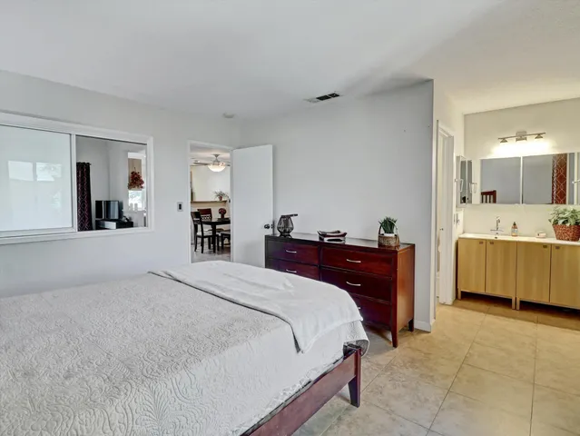 a bed room with a bed and a large mirror