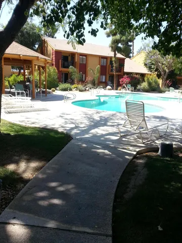 a view of a patio with table and chairs
