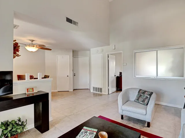 a living room with furniture and a mirror