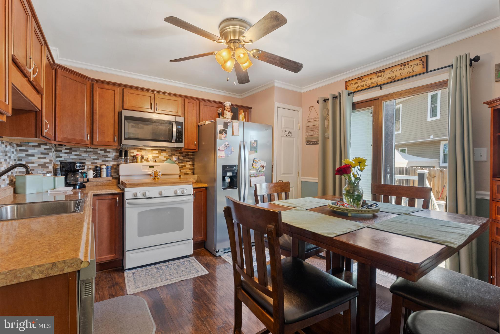 70 Del Rio Road Baltimore, MD 21222 - Photo 6 of 40 a kitchen with stainless steel appliances granite countertop a stove a refrigerator a kitchen island a table and chairs