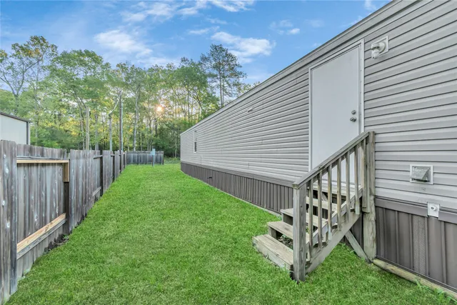 a view of a house with backyard and a garden