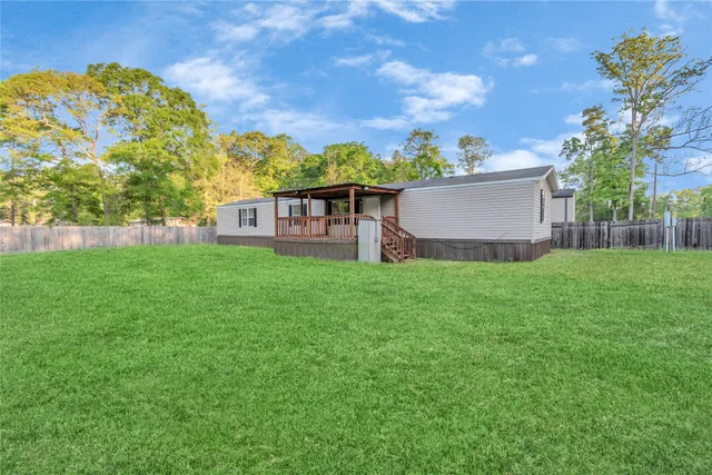 a view of a house with a yard and sitting area