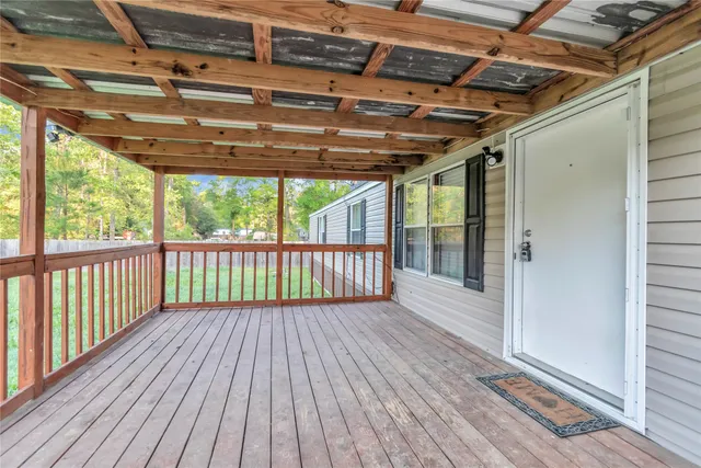 a view of porch with wooden floor
