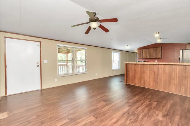 a view of a kitchen with a dishwasher cabinets and wooden floor