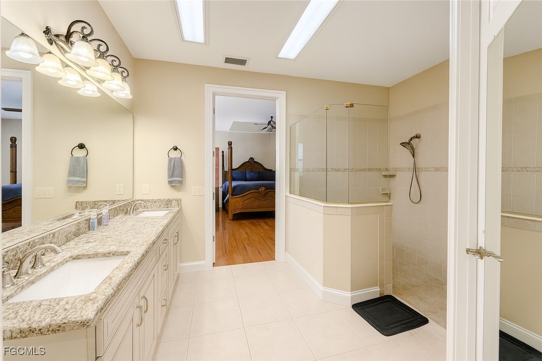 965 Stenstrom Road Wauchula, FL 33873 - Photo 16 of 25 a en suite bathroom with a granite countertop sink a mirror and shower