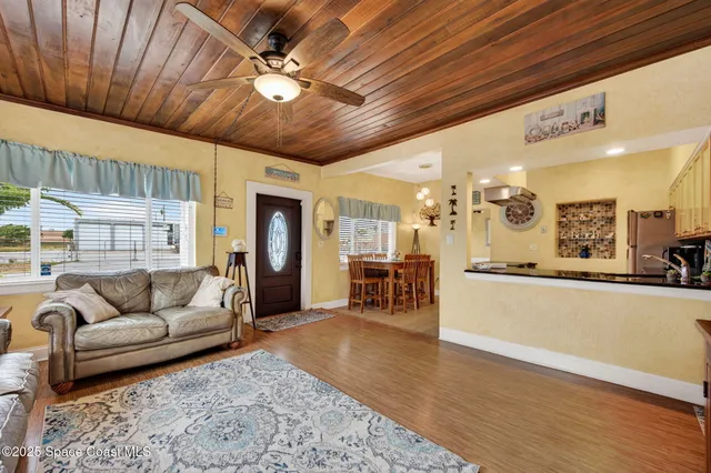 a living room with furniture and kitchen view