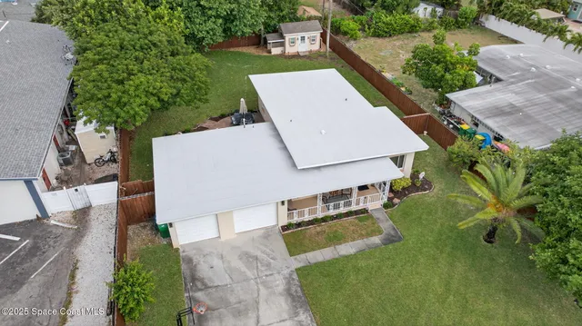 an aerial view of a house with swimming pool and patio