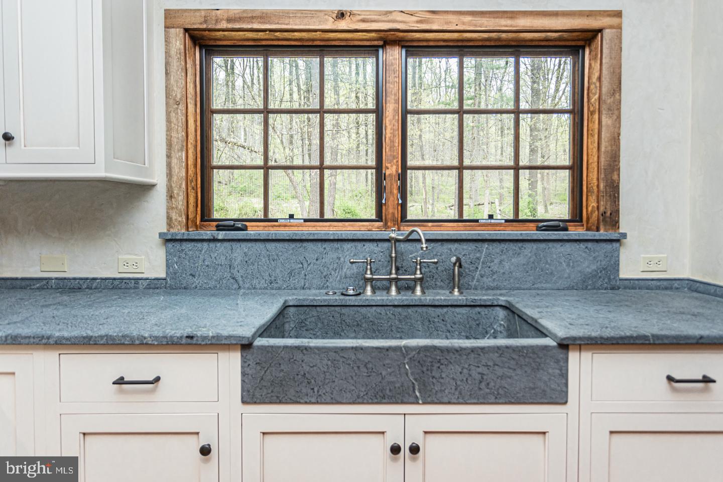 340 Thompson Mill Road New Hope, PA 18938 - Photo 19 of 76 a kitchen with granite countertop a sink window and cabinets